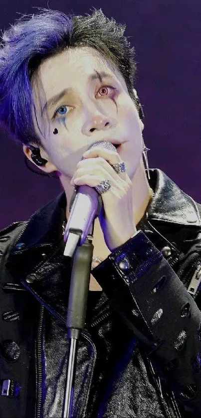 Performer with edgy makeup and leather jacket on stage.