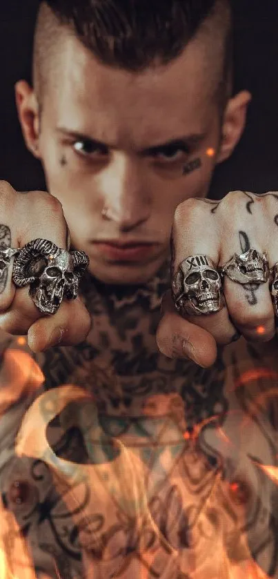 Tattooed man with skull rings on dark background.