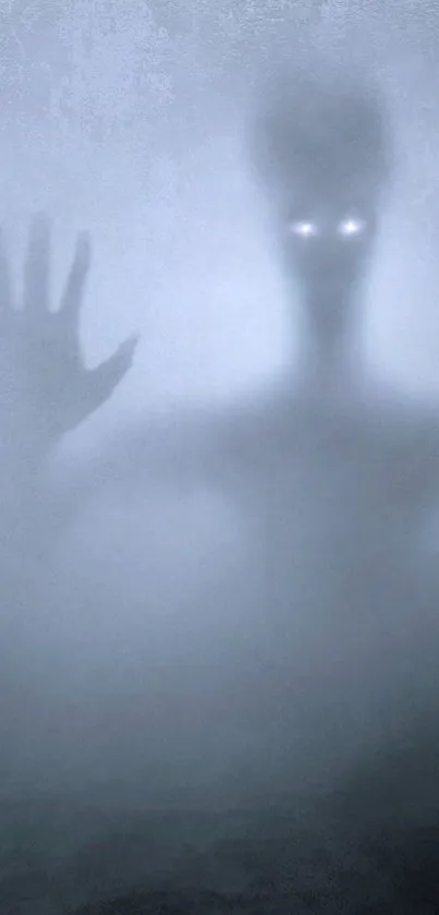 A shadowy alien figure with glowing eyes on a foggy gray background.