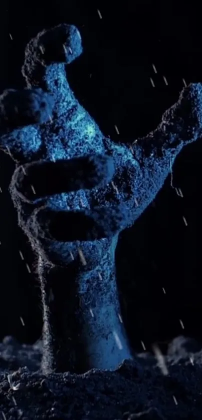 Eerie blue hand reaching up in dark rain, spooky wallpaper.