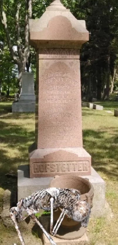 Eerie scene of a skeleton near a headstone in a lush green cemetery.