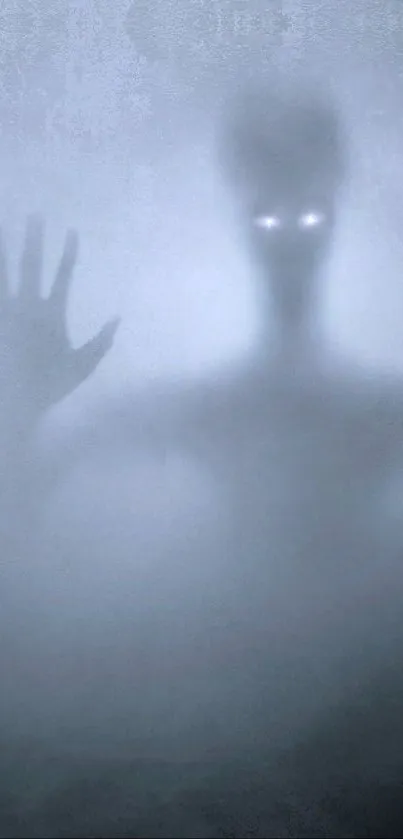 Eerie wallpaper featuring a foggy silhouette with glowing eyes.