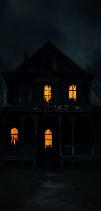 Haunted house at night with glowing windows, creating an eerie atmosphere.
