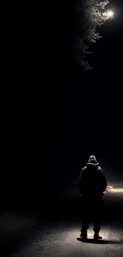 Silhouette on a dark, dimly lit road at night wallpaper.