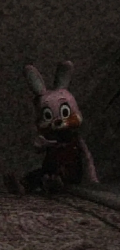 Eerie plush bunny sitting in darkness with a mysterious vibe.