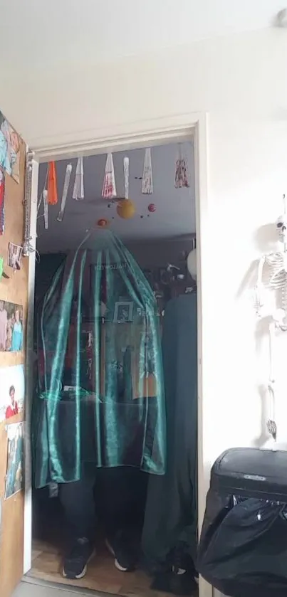 Eerie room with skeleton decor and teal drapery.