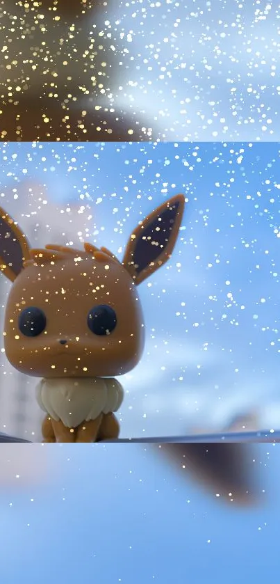 Eevee figurine with golden sparkles on a blue sky background.