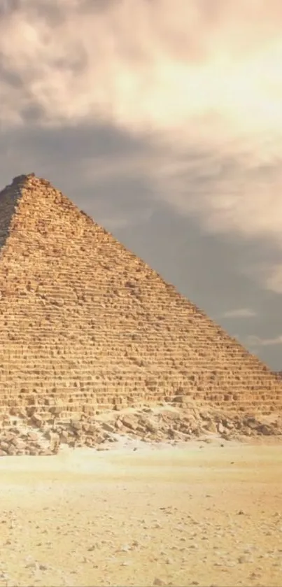 Egyptian pyramid in desert under dramatic sky.