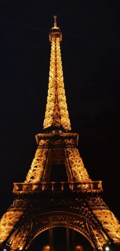 Eiffel Tower lit up against a dark night sky.