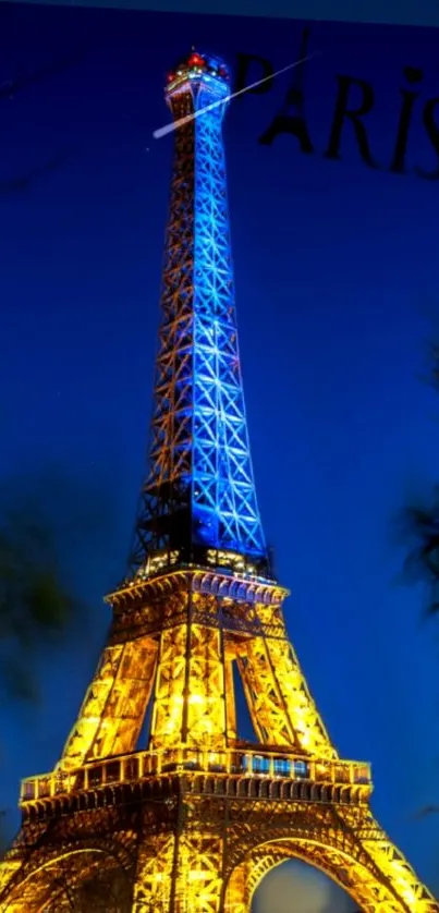 Eiffel Tower illuminated at night against a deep blue sky.