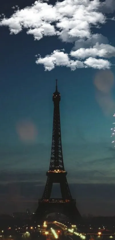 Eiffel Tower under a night sky with clouds and fireworks.