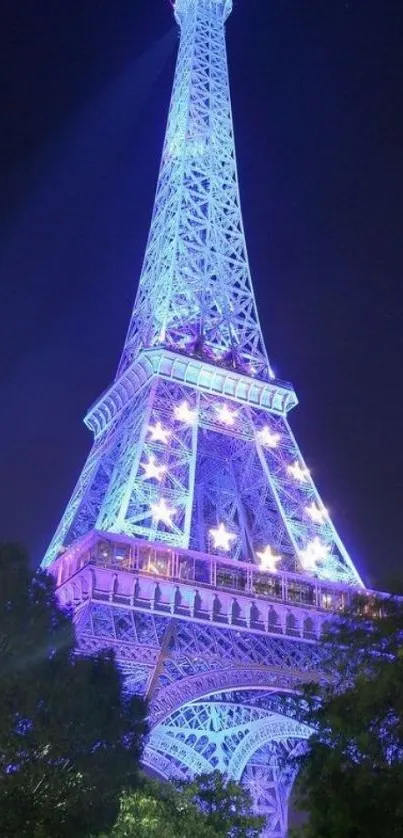 Illuminated Eiffel Tower at night with vibrant blue hues against the night sky.