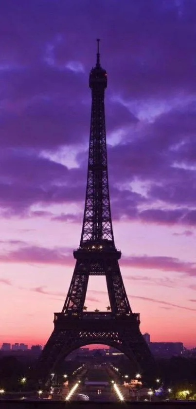 Eiffel Tower silhouette with a purple sunset sky in the background.