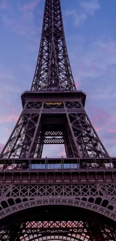 Eiffel Tower silhouette at sunset with a vibrant purple sky background.