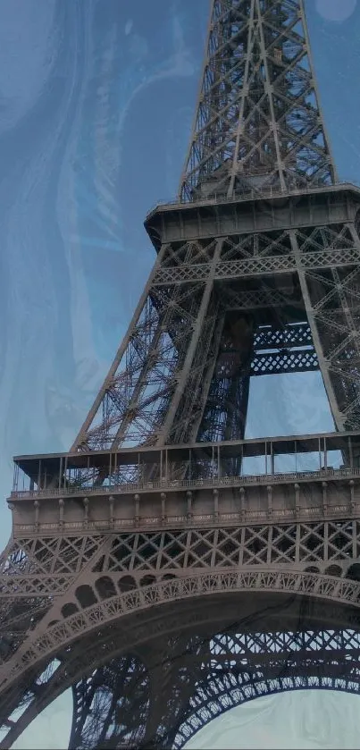 Eiffel Tower against a blue, abstract sky background.