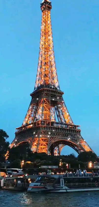 Illuminated Eiffel Tower against blue evening sky.