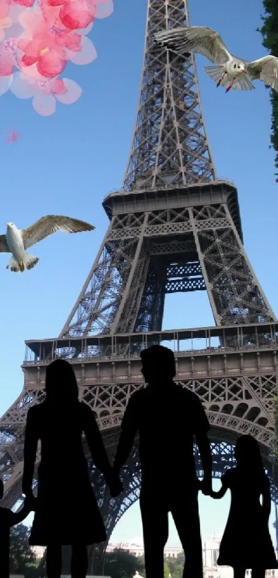 Eiffel Tower silhouette with family under cherry blossoms.