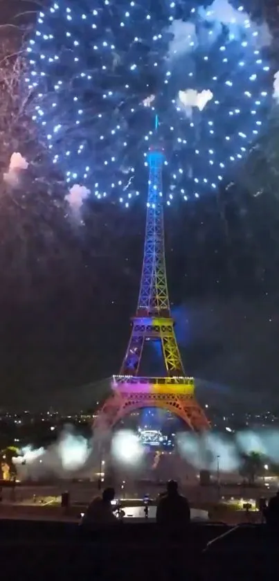 Eiffel Tower illuminated by fireworks at night.