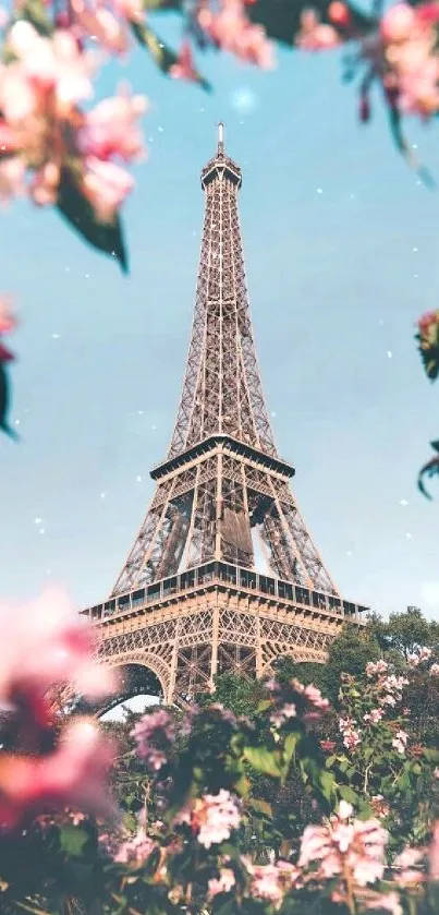 Eiffel Tower framed by flowers against a blue sky in Paris.