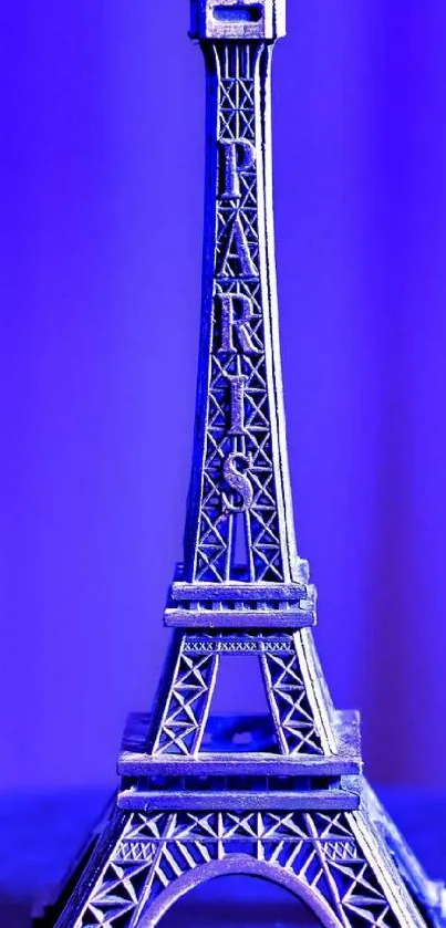 Eiffel Tower miniature in neon blue tones, Parisian style.