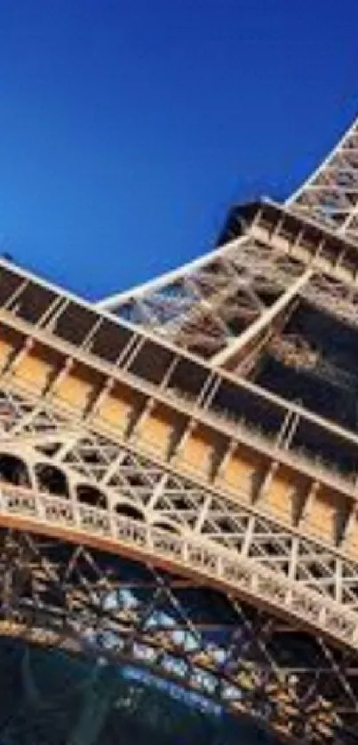 Elegant close-up of the Eiffel Tower against a clear blue sky.