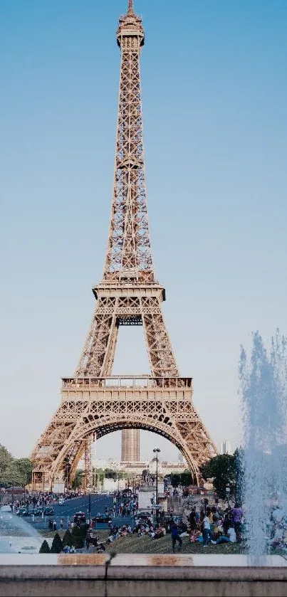 Eiffel Tower against a clear blue sky with fountains in the foreground.