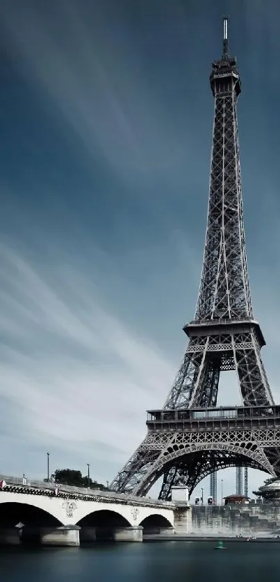 Eiffel Tower with a dramatic sky and bridge in view.