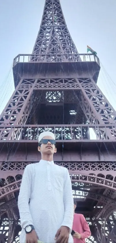 Individual in front of the Eiffel Tower, showcasing fashion and architecture.