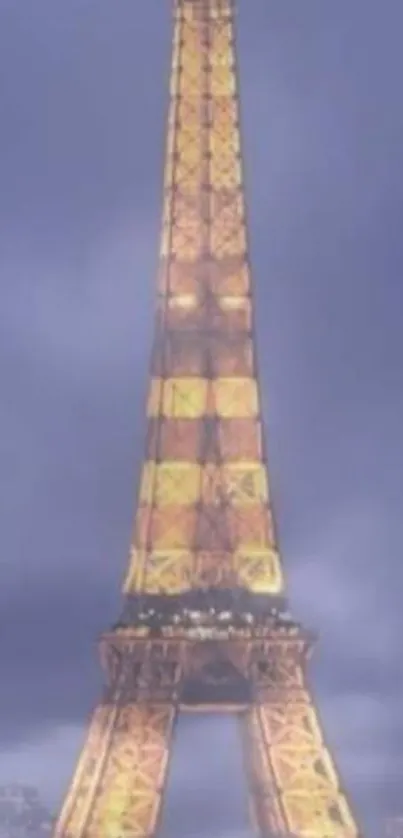 Glowing Eiffel Tower at night with a dusky purple sky.