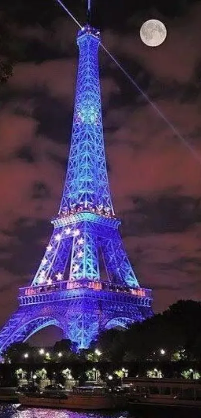 Eiffel Tower illuminated against a purple night sky with the moon in the background.