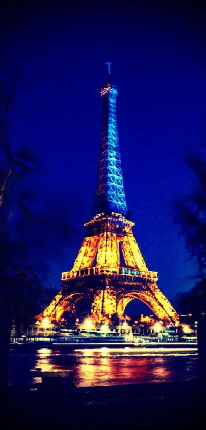 Eiffel Tower illuminated at night against a deep blue sky.