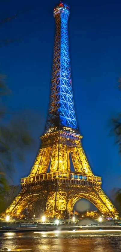 Eiffel Tower illuminated at night with a dark blue sky backdrop.