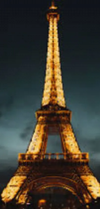 Eiffel Tower illuminated at night with dark sky background.