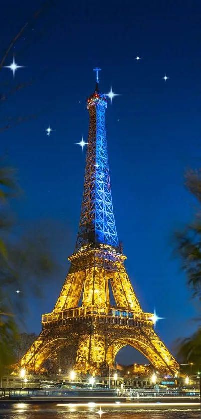 Eiffel Tower illuminated at night with scenic plants in foreground.