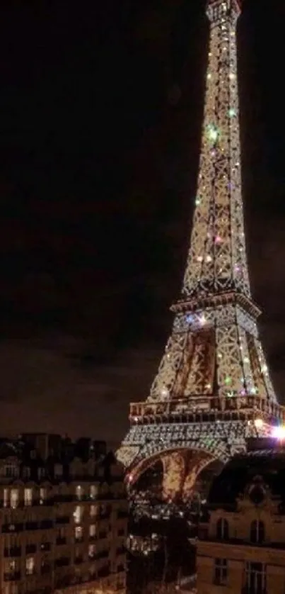 Illuminated Eiffel Tower against the night sky in Paris.