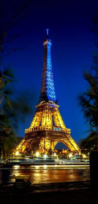 Illuminated Eiffel Tower at night with dark blue sky.