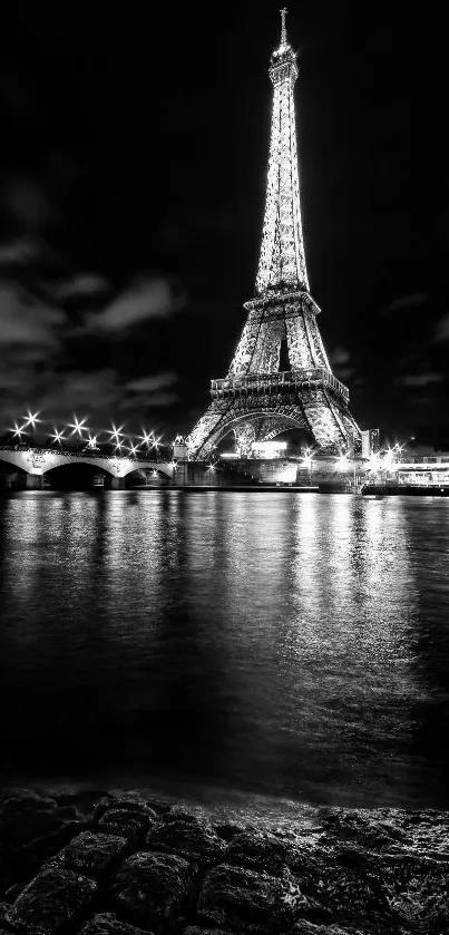 Black and white Eiffel Tower night view with Seine reflection.