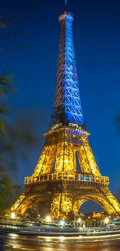 Illuminated Eiffel Tower at night with deep blue sky backdrop.