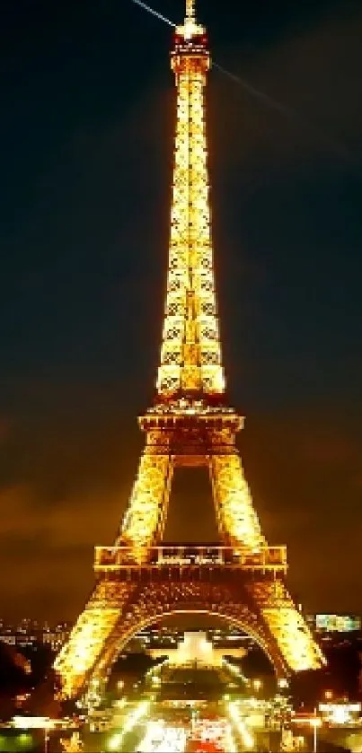 Eiffel Tower illuminated at night against a dark sky in Paris.