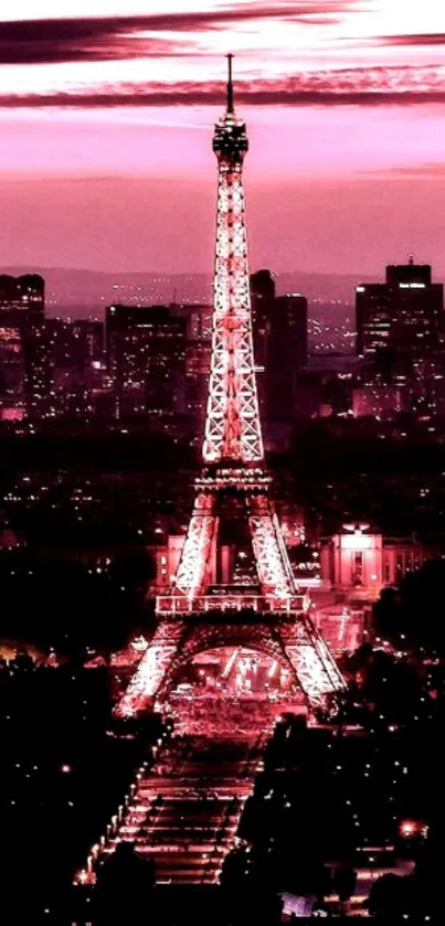 Eiffel Tower at night with pink cityscape background.