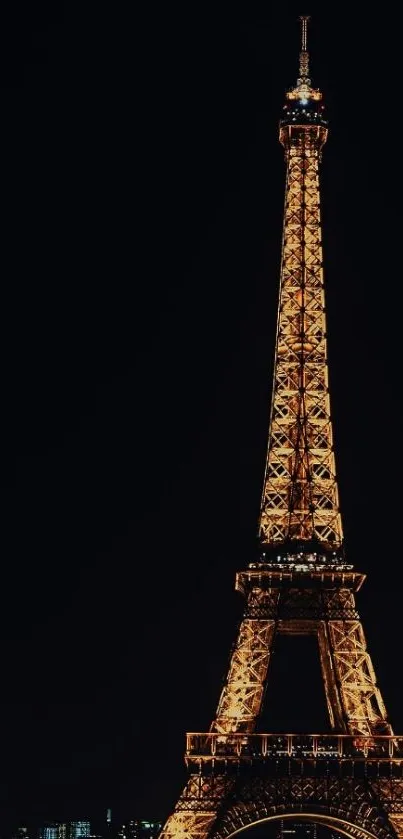 Eiffel Tower glowing against the night sky in Paris, perfect for mobile wallpaper.