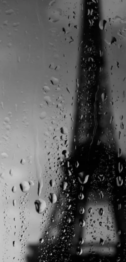 Eiffel tower seen through raindrops on glass, black and white wallpaper.