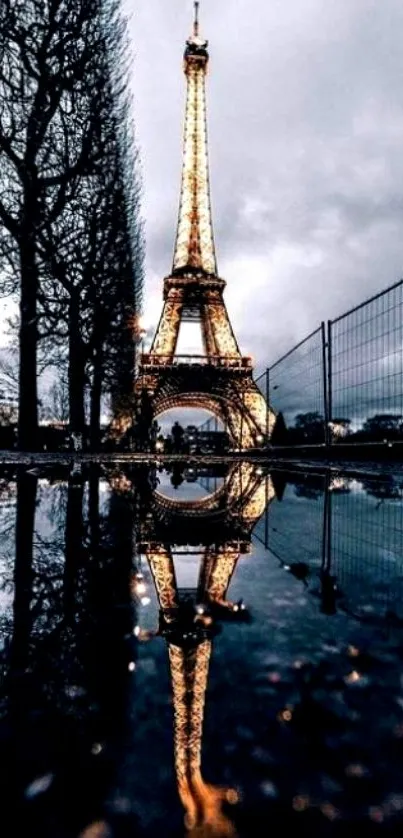 Eiffel Tower at night with reflection in water, creating a stunning visual display.