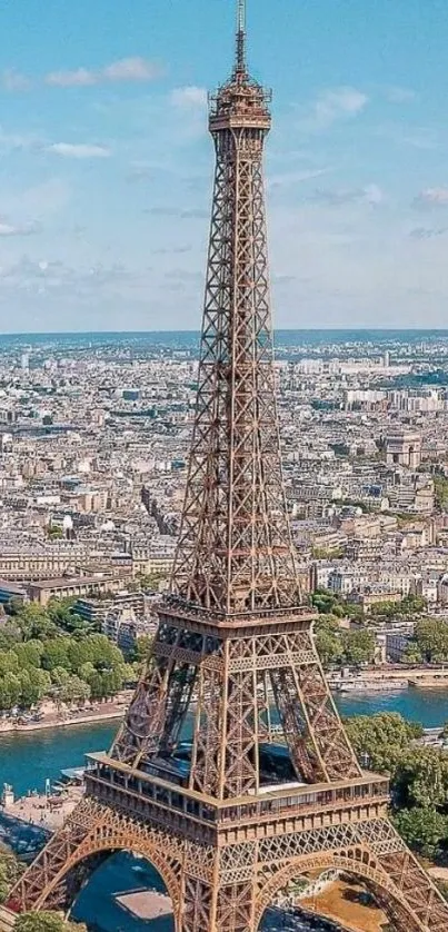 Aerial view of the iconic Eiffel Tower in Paris under a bright blue sky.