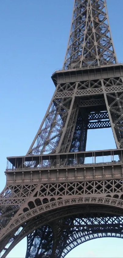 Eiffel Tower with blue sky background, highlighting its intricate iron design.