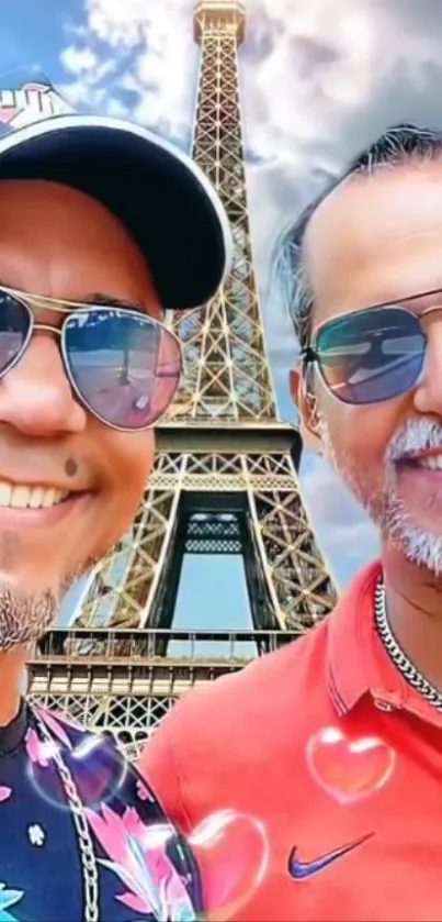 Two men smiling in front of the Eiffel Tower with a sky backdrop.