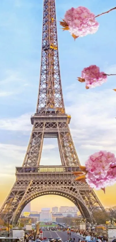 Eiffel Tower with pink blossoms against a blue sky.