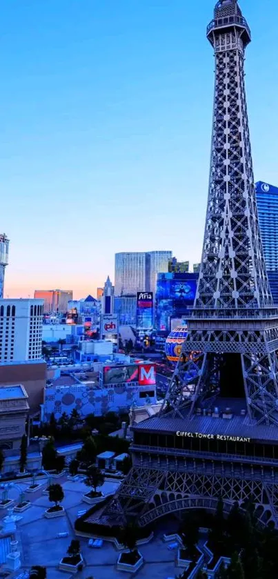 Elegant Eiffel Tower at sunset with blue sky and urban backdrop.