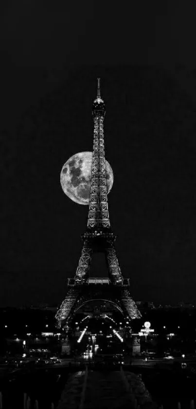 Eiffel Tower with full moon backdrop in black and white.