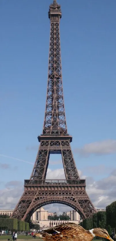 Eiffel Tower with a duck in front under a clear sky.